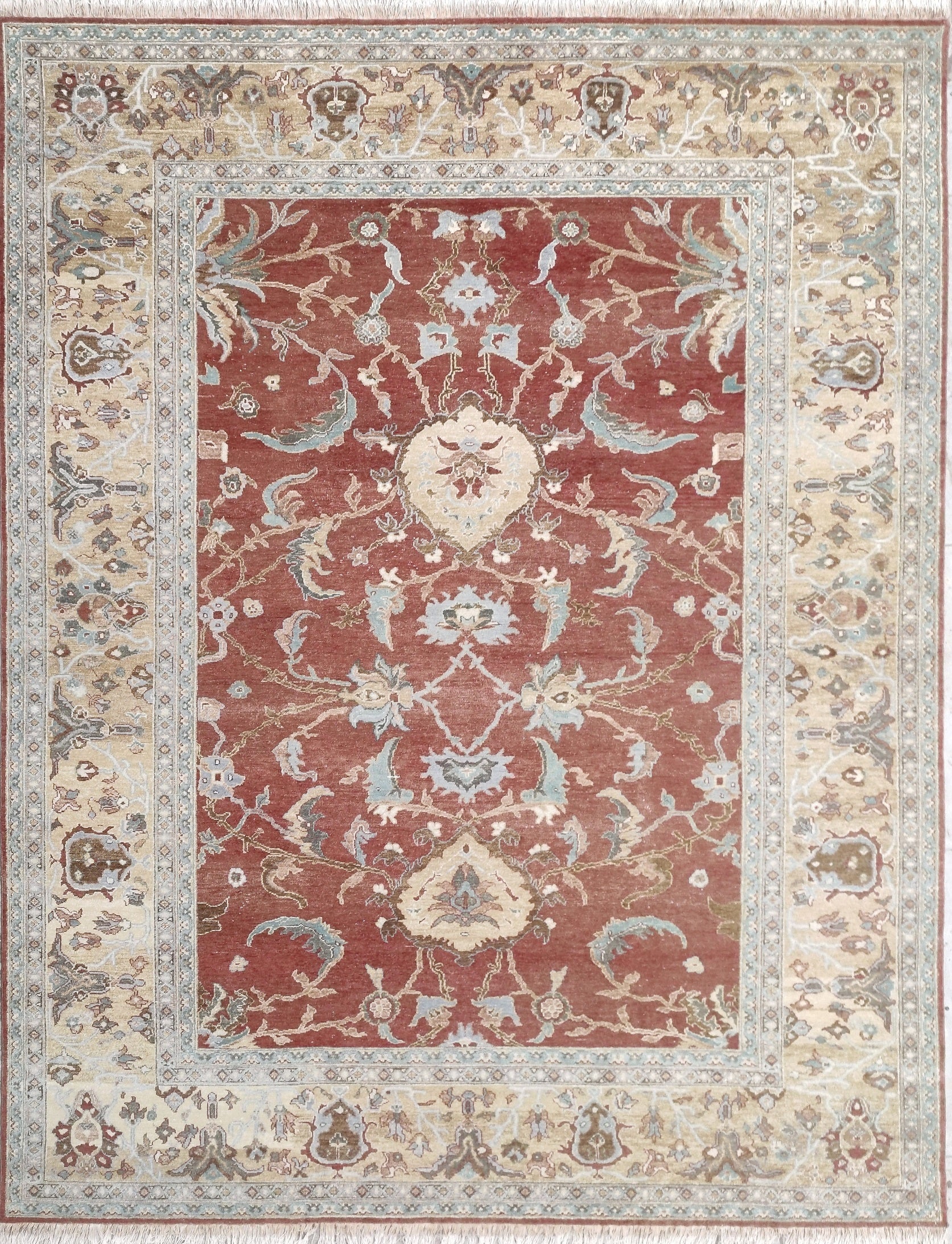 Decorative rug with intricate patterns on a red and beige background