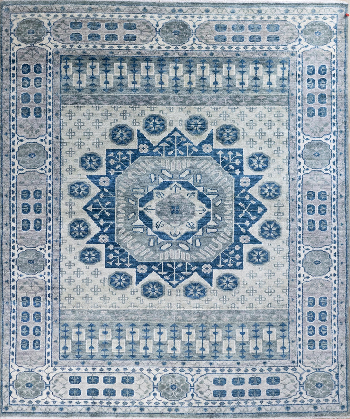 Decorative blue and white patterned rug with intricate designs